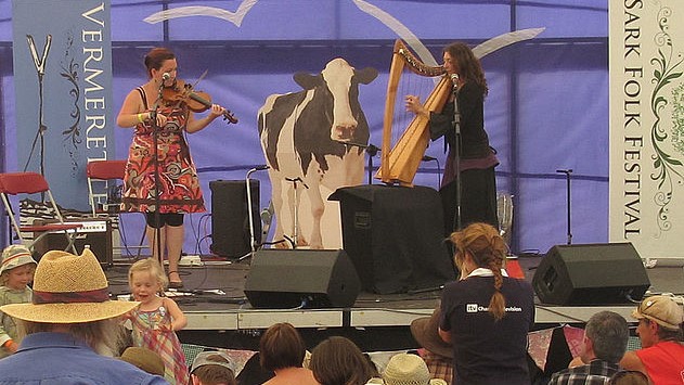 Musician girls and cow