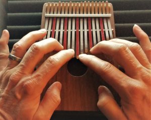 finger playing the Kalimba